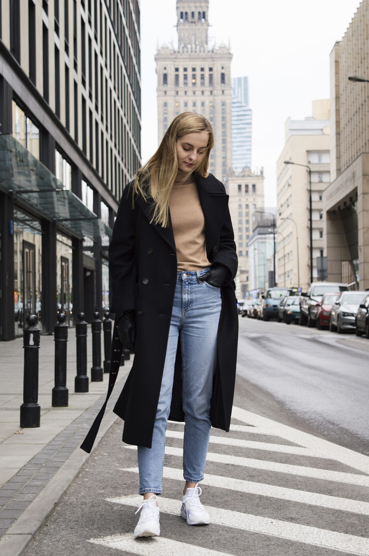 Girl on the street with navy blue H&M coat, blue jeans and camel turtleneck