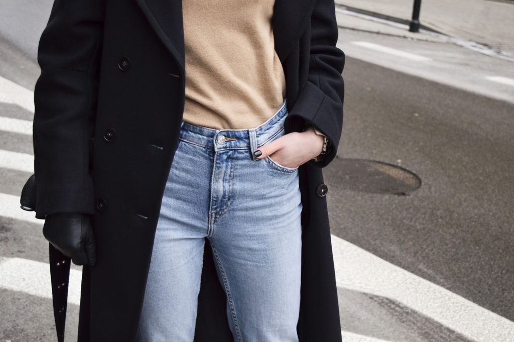Girl on the street with navy blue H&M coat, blue jeans and camel turtleneck